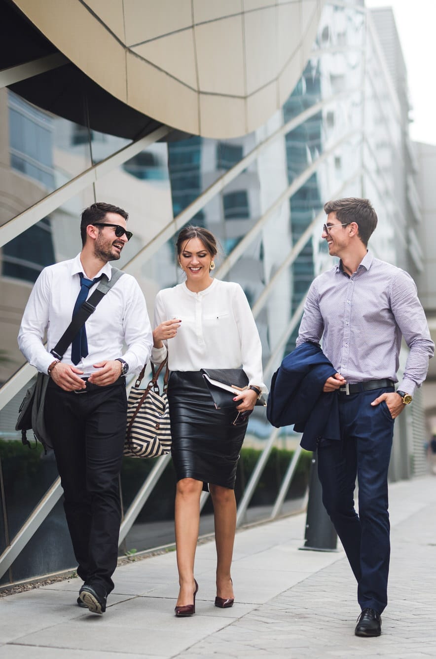 Elegant,Businesspeople,Walking,In,A,Modern,City. Tech and B2B PR Team Meeting