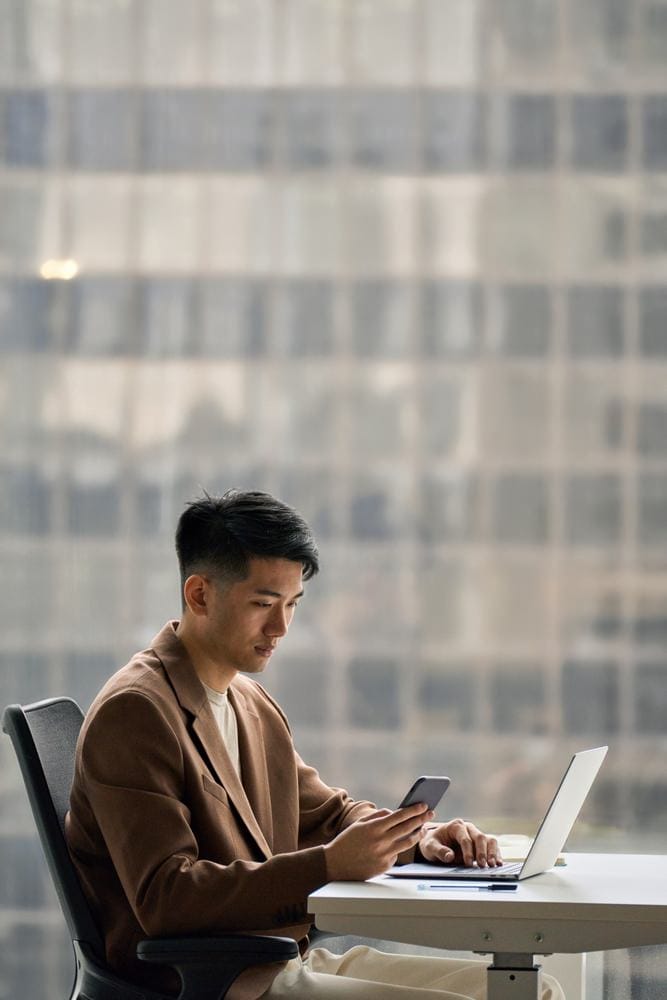 Young,Busy,Smart,Serious,Asian,Japanese,Business,Man,Executive,Holding Businessperson using mobile phone for social media management for PR.