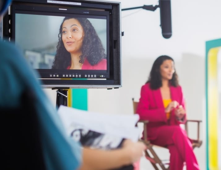 Vibrant,On-set,Image,Of,A,Young,Black,Female,Host,In Woman being filmed<br />