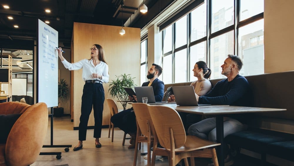 Journalists and media professionals asking questions during a live press conference in a government building—capturing media engagement, public relations in action, and press access.
